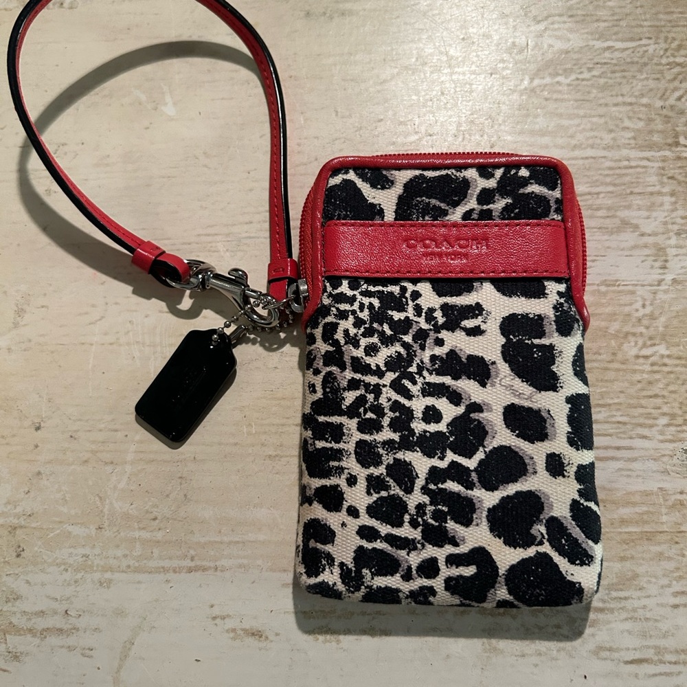 Small coach wristlet animal print with reddish peach leather trimmings